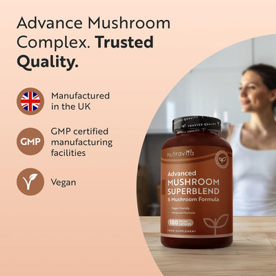 A bottle of NutraVita Advanced Mushroom Superblend 4 Mushroom Formula food supplement is featured on a light peach background with marketing text highlighting 'Trusted Quality', 'Manufactured in the UK', 'GMP certified manufacturing facilities', and 'Vegan'. A blurred woman is visible in the background of the product photo.