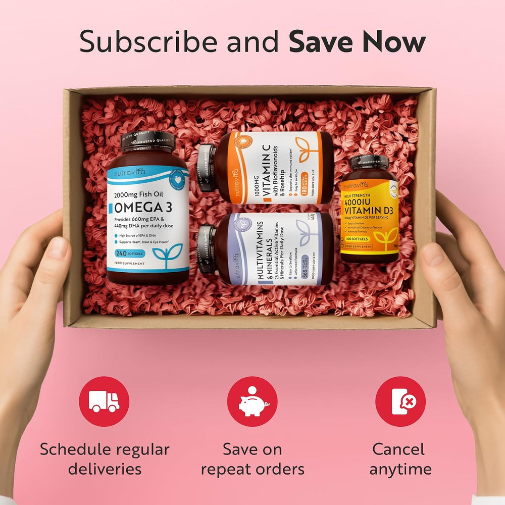 A pair of hands holds a cardboard gift box filled with pink crinkle paper, containing four supplement bottles: Omega 3, Vitamin, Multivitamins, and Vitamin D. The background is pink with text reading 'Subscribe and Save Now' and three feature icons below.