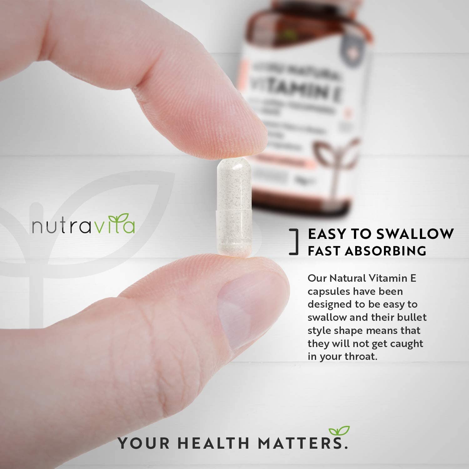 Hand holding a vitamin E capsule with Nutravita branding and product description.